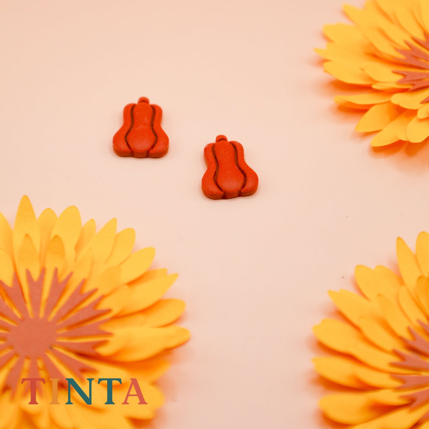 Decorative orange flowers and pumpkins on a peach background with 'TNTA' branding.