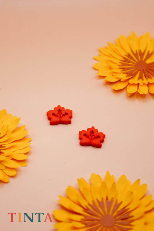 Decorative yellow flowers and red floral elements on a beige background with 'TINTA' branding.