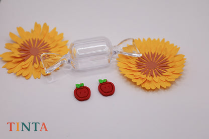 Clear candy with yellow sunflower-shaped ends on a white background, featuring the brand 'TINTA'.