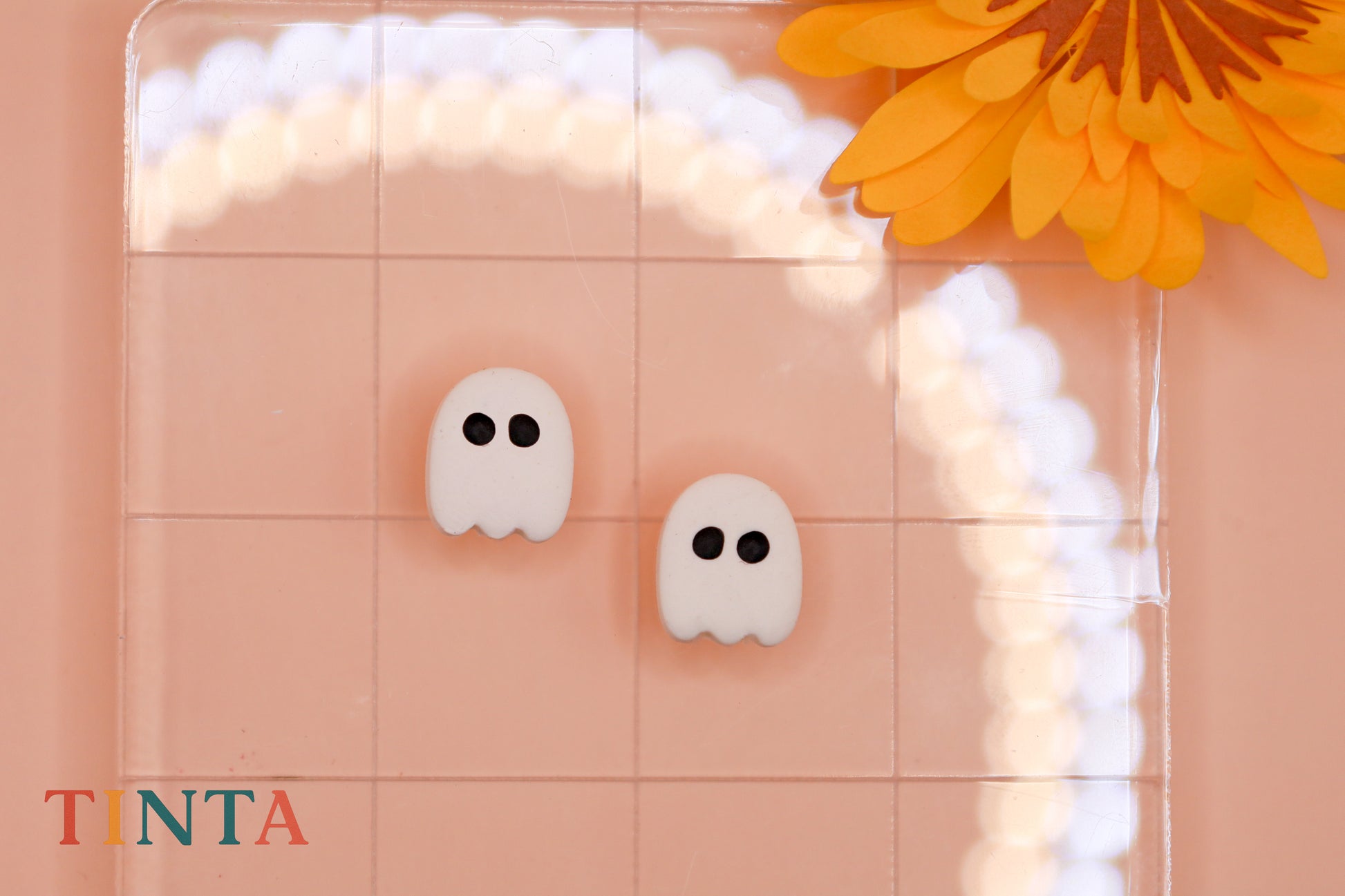 TINTA makeup product with ghost designs on a pink background