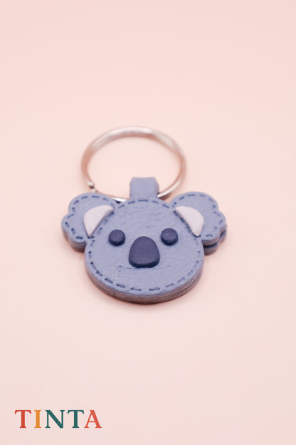 Keychain shaped like a koala on a pink background with 'TINTA' branding.