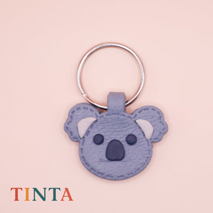 Keychain shaped like a koala on a pink background with 'TINTA' branding.
