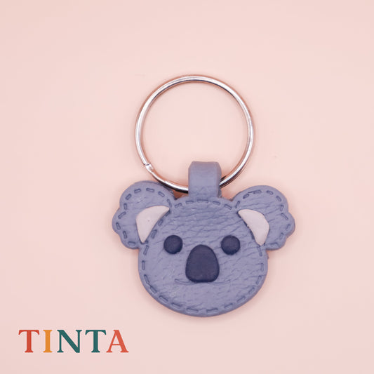 Keychain shaped like a koala on a pink background with 'TINTA' branding.